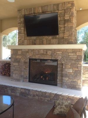 A stone outdoor fireplace done by Pacific Hearth & Home in Rancho Cordova, CA