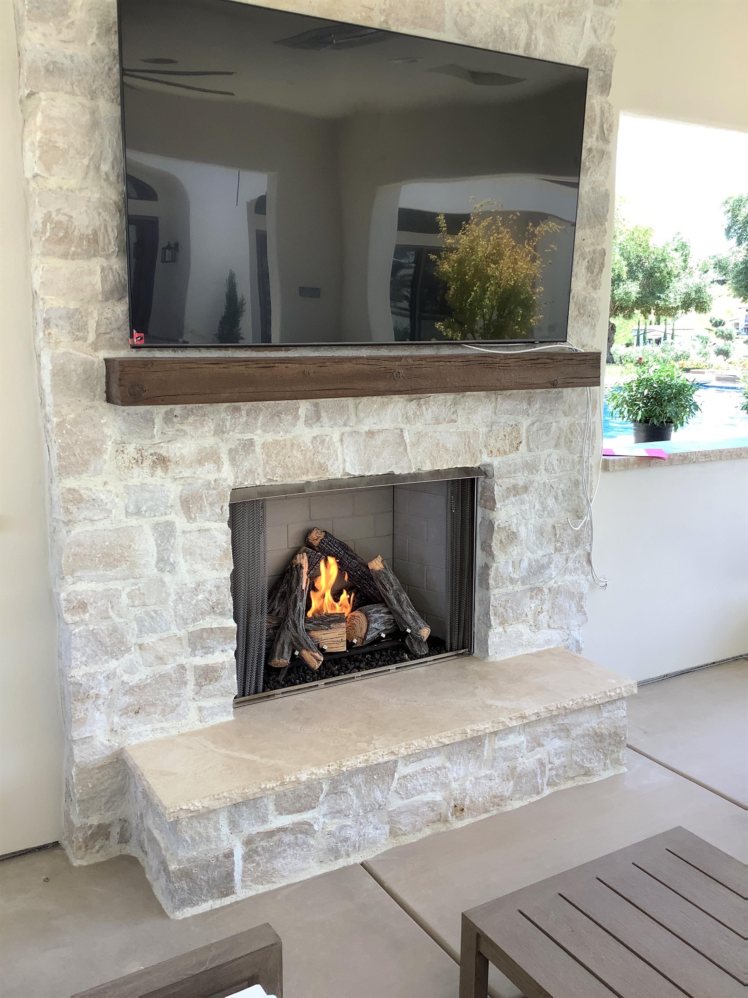 A stone outdoor fireplace done by Pacific Hearth & Home in Rancho Cordova, CA